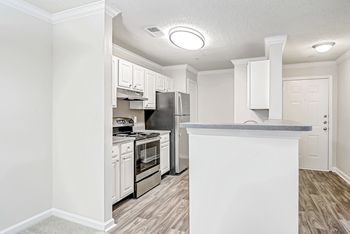 a kitchen with white cabinetry and stainless steel appliances